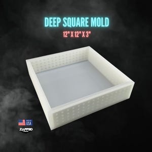 May include: A white silicone mold for making square objects. The mold is 12 inches by 12 inches by 3 inches. It has a textured surface.