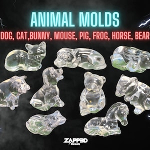 May include: Clear plastic molds of various animals, including a dog, cat, bunny, mouse, pig, frog, horse, and bear. The molds are arranged on a black background with lightning bolts in the corners. The text "ANIMAL MOLDS" and "DOG, CAT, BUNNY, MOUSE, PIG, FROG, HORSE, BEAR" is displayed above the molds.