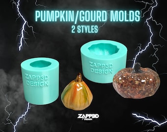 May include: Two teal blue silicone molds for making pumpkin or gourd shaped crafts. The molds are labeled "ZAPP3D DESIGN". One mold is a round shape and the other is a more detailed pumpkin shape. There are two finished pumpkins in the image, one is a brown and gold color and the other is a multi-colored pumpkin.