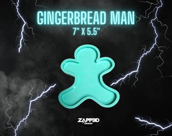 May include: A turquoise gingerbread man-shaped mold, measuring 7" x 5.5", is displayed against a dark background with lightning bolts and fog effects. The text "GINGERBREAD MAN" is above the mold, and the Zapp3D Design logo is at the bottom.