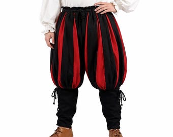 Peut inclure: Une chemise blanche à manches longues avec encolure et poignets froncés, associée à une culotte bouffante à rayures verticales noires et rouges, dotée d'une taille à cordon et de bas de jambes noirs ajustés avec des lacets latéraux.