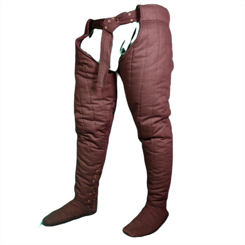 Angled front view of brown quilted medieval leg wrappings with side lacing on the lower legs.