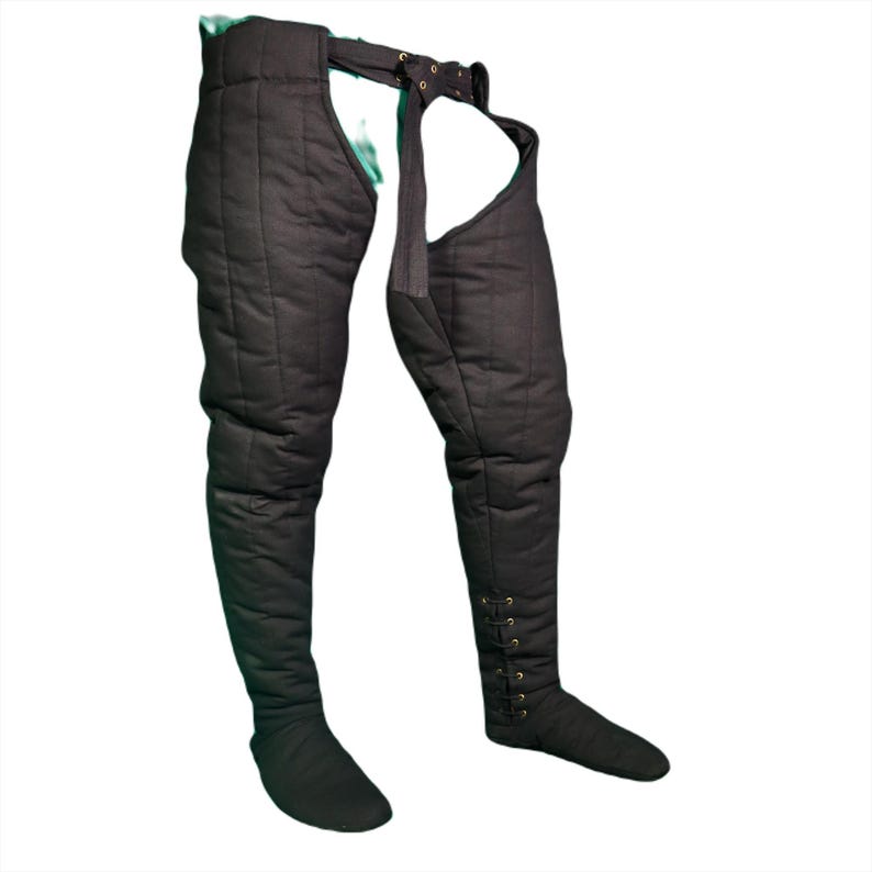 Front view of black quilted medieval leg wrappings with a buckled belt and integrated foot covers.