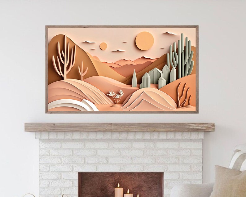 May include: A paper art print depicting a desert landscape with cacti and mountains in shades of brown, beige, and green. The print is framed in a light brown wood frame.