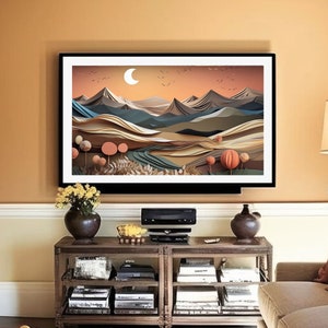 May include: A framed print of a paper art landscape featuring mountains, trees, and a crescent moon. The colours are muted and earthy, with shades of brown, green, and blue.