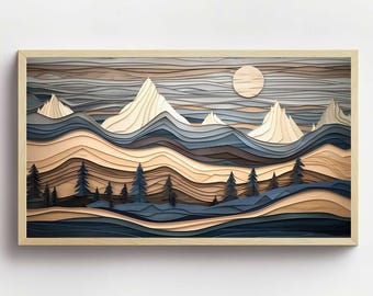 Puede incluir: Una impresión de arte en papel enmarcada que representa un paisaje montañoso en capas con una luna llena en el cielo. Las montañas están hechas de papel y están superpuestas en tonos de azul, marrón y blanco. El cielo es un degradado de azul y gris. La impresión está enmarcada en un marco de madera claro.
