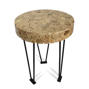 May include: A round side table with a top made of small, light-colored wood pieces. The table has black metal hairpin legs. The table is approximately 20 inches in diameter and 20 inches tall.