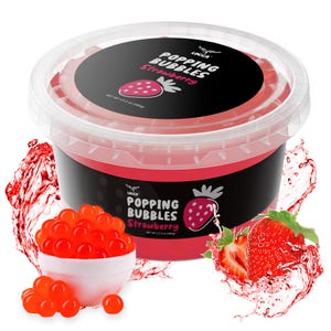 May include: A clear plastic container of strawberry-flavored popping bubbles. The container has a black label with the words "Popping Bubbles Strawberry" and a strawberry graphic. A small white bowl holds a serving of the red bubbles, with a strawberry and splash of liquid.