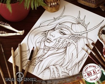 May include: A black and white line drawing of a woman with a crown and intricate details on her face and hair. The drawing is on a white sheet of paper, surrounded by art supplies, including paintbrushes, a paint palette, and a skull.