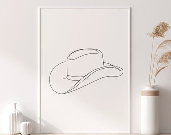 Könnte beinhalten: Gerahmter minimalistischer Kunstdruck mit einem Cowboyhut. Die schwarze Kunst ist auf weißem Hintergrund dargestellt. Der Druck wird auf einem hellen Holzregal mit dekorativen Vasen und getrockneten Pflanzen präsentiert.