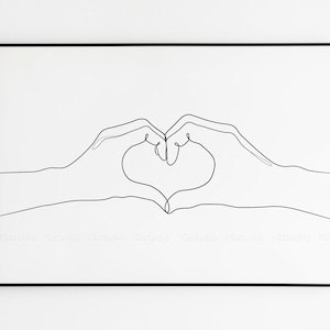 May include: Black framed art print featuring a minimalist line drawing of two hands forming a heart shape. The artwork is in black and white, with the hands' outlines creating the heart. The background is white.