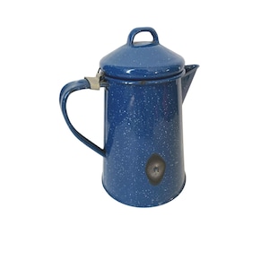 May include: A blue speckled enamelware coffee pot with a lid and handle. The pot has a spout for pouring and a loop handle on the lid. The pot is a classic camping or outdoor cooking item.