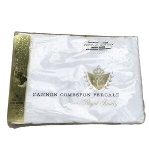 May include: A white Cannon Combspun Percale fitted sheet for a double bed, packaged in clear plastic. The label features the text "FLEX-O-MATIC," "Royal Family," and "DOUBLE BED FITTED BOTTOM 54 x 75," with a gold-colored decorative side panel.