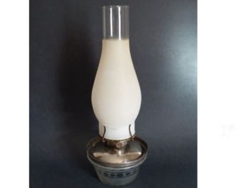 May include: A white glass oil lamp with a silver base and a black and white patterned design.