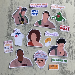 May include: A set of Ghostbusters themed stickers featuring characters from the film, including the Stay Puft Marshmallow Man, a Ghostbuster, and Slimer. The stickers also include text from the film, such as "Back Off Man I'm a Scientist", "Who You Gonna Call?", and "Keymaster".