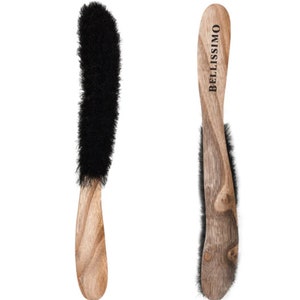 May include: Two wooden brushes with black bristles. The handles are a light brown color and have a curved shape. The text "BELLISSIMO" is printed vertically on one of the handles. The brushes are designed for applying cosmetics or other beauty products.