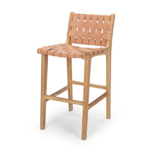 May include: A light brown wooden bar stool with a woven leather seat and back. The stool has four legs and a footrest. The leather is a light tan colour, and the wood has a natural finish.