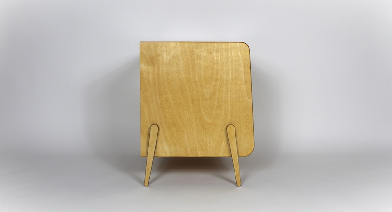 May include: A light wood cabinet with a rounded edge and four legs. The cabinet is made of plywood and has a natural wood finish.