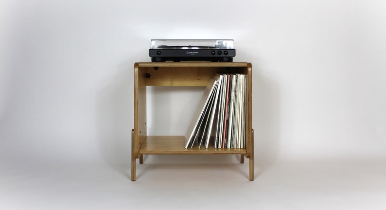 May include: A wooden record player stand with a turntable on top and a shelf below for storing vinyl records.