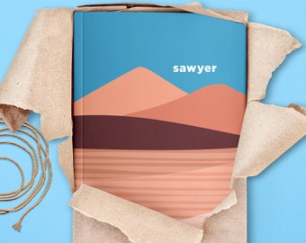 May include: A brown paper package with a torn edge revealing a book with a blue sky, orange and brown hills, and the word "sawyer" printed on the cover.