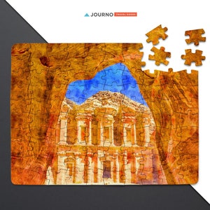 May include: A watercolor-style jigsaw puzzle featuring the Treasury building in Petra, Jordan. The puzzle is partially assembled, with some pieces missing. The Treasury is a sandstone building with a facade carved into the rock face. The puzzle is set against a white background.