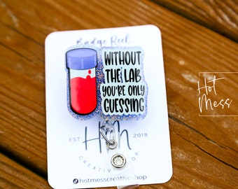 May include: A blue and red glitter badge reel with a test tube and the text "Without the lab you're only guessing".