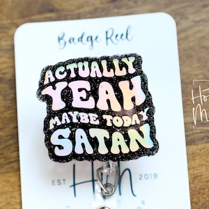 Puede incluir: Un carrete de credencial negro con purpurina con una pegatina holográfica que dice "Actually Yeah Maybe Today Satan".