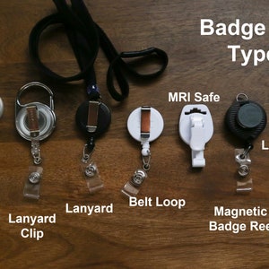 May include: A selection of badge reel types, including alligator clip, lanyard clip, lanyard, belt loop, MRI safe, magnetic badge reel, and a lapel pin. The text "Badge Reel Types" is displayed at the top.