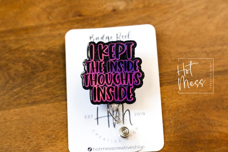 May include: A black and pink glitter badge reel with the text "I kept the inside thoughts inside".