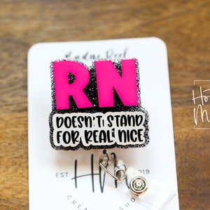 May include: A black and silver glitter badge holder with a pink "RN" and the text "Doesn't stand for real nice".