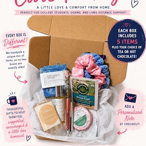 May include: A cardboard gift box containing five items: a blue marbled soap bar, a bottle of vanilla hand sanitizer, a small oil vial, a metallic pen, a packet of organic stress relief tea, a round lemon eucalyptus tin, and two fabric hair scrunchies.