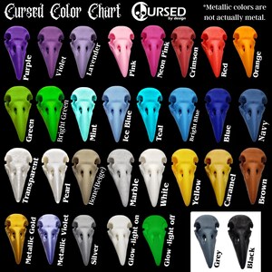May include: Color chart showing 24 different colors of bird skull charms. The colors include purple, green, transparent, metallic gold, violet, bright green, pearl, metallic violet, lavender, silver, mint, bone beige, pink, ice blue, glow-light on, glow-light off, marble, white, teal, bright blue, yellow, grey, caramel, black, blue, neon pink, crimson, red, orange, and navy. The text "Cursed Color Chart" is at the top of the chart. The text "*Metallic colors are not actually metal." is at the top right of the chart.