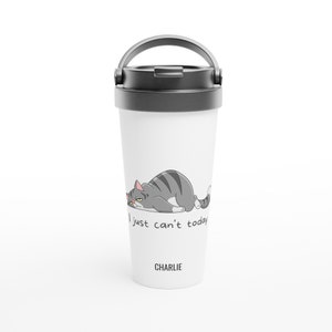 May include: White travel mug with a grey lid and handle. A cartoon grey cat with pink nose and ears is lying down with the text "I just can't today" and the name "CHARLIE" below the cat.