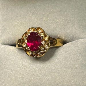 Ring Avon Gold tone, oval cut ruby red, Vintage