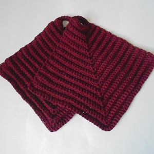 May include: Two burgundy crocheted pot holders with a square shape.