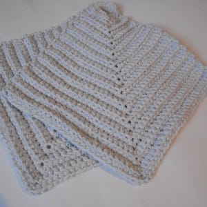 May include: A light blue crocheted scarf with a textured pattern.
