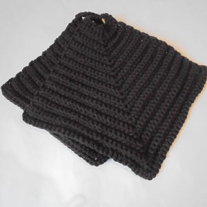 May include: Two black crocheted pot holders, folded together. The pot holders are made with a simple stitch pattern and have a square shape.