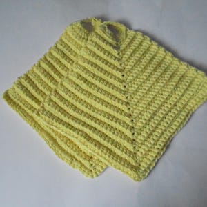 May include: Two yellow crocheted pot holders with a textured striped pattern.