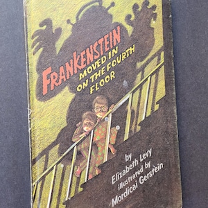 May include: Vintage children's book cover titled "Frankenstein Moved in on the Fourth Floor." The cover features a shadowy monster, two children on stairs, and the author and illustrator's names.