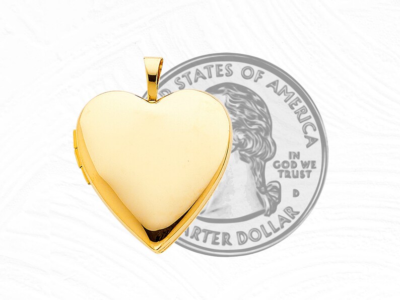 May include: A gold heart-shaped locket pendant, approximately the size of a US quarter dollar.