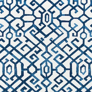 May include: A white fabric with a blue geometric pattern. The pattern is made up of repeating squares and diamonds.
