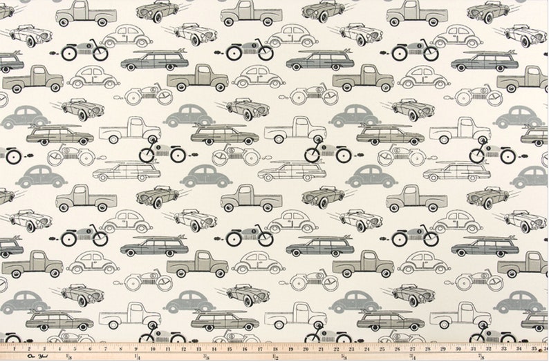 May include: A white fabric with a repeating pattern of grey and black cars, trucks, and motorcycles. The pattern is in a vintage style.