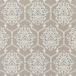 May include: A beige fabric with a white and black damask pattern. The pattern features a repeating design of stylized floral motifs.