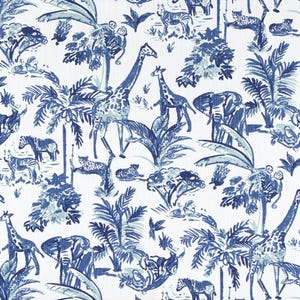 May include: A white fabric with a blue and white pattern of giraffes, zebras, elephants, and palm trees. The pattern is repeated throughout the fabric.
