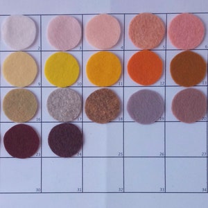 May include: A color chart with 35 felt fabric swatches in various colors, including white, yellow, orange, brown, gray, and red. The swatches are arranged in a grid pattern.