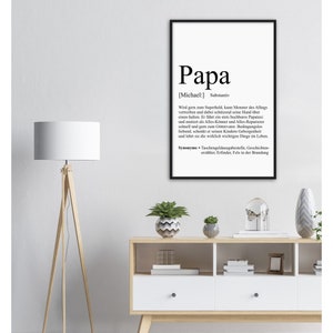 May include: Black and white printable wall art with a definition of the word "Papa" in German. The definition describes a father as a superhero, protector, and provider.