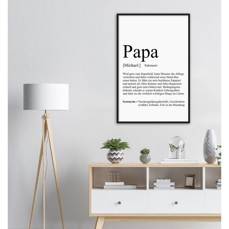 May include: Black and white printable wall art with a definition of the word "Papa" in German. The definition describes a father as a superhero, protector, and provider.