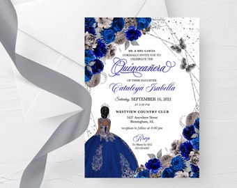 May include: A Quinceañera invitation with a blue and silver floral design. The invitation features a silhouette of a young woman in a blue dress and a crown. The text on the invitation reads "Quinceañera" and "Cataleya Isabella".