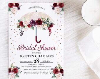 May include: Bridal shower invitation with a watercolor illustration of a white lace umbrella with burgundy and pink flowers. The text reads "Please join us for a Bridal Shower honoring Kristen Chambers, Saturday, August 28, 2PM-4PM, Lakeview Clubhouse, 5144 Anywhere Road, Savannah, GA 12345, Please RSVP to Sarah at 555.123.4567, Registered at Target & Macy's".
