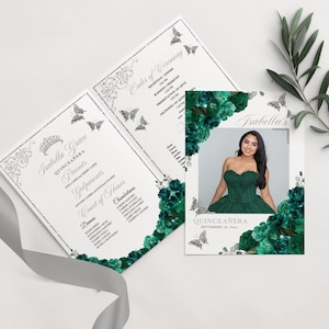 May include: A Quinceañera invitation with a silver and white background featuring a floral design with butterflies. The invitation includes the name Isabella Grace, the date September 16, 20**, and a photo of the Quinceañera in a green dress.